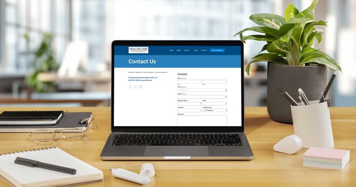 Healthcare ITSM contact page displayed on a laptop in a modern office workspace.